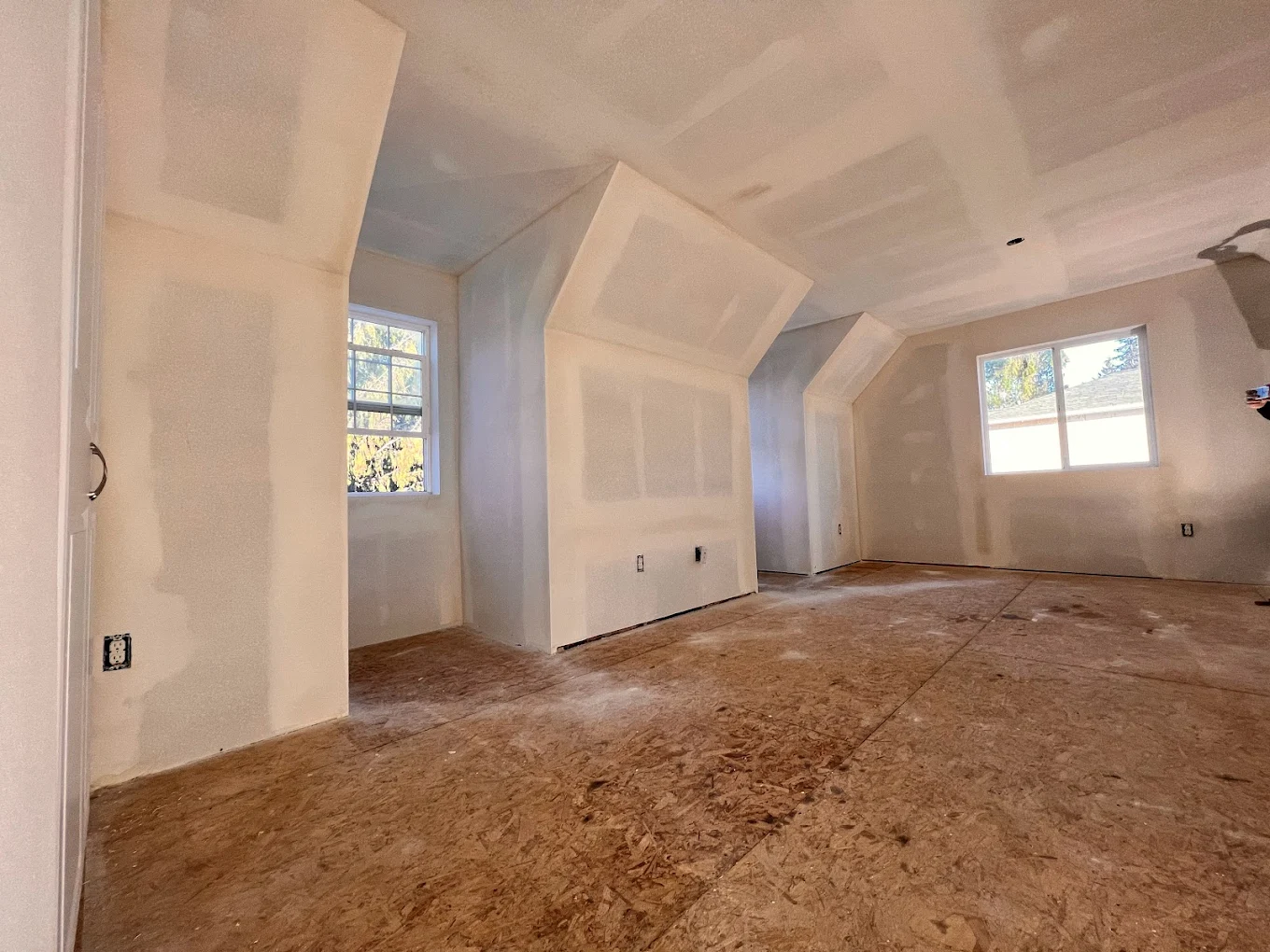 Attic before — bare studs, exposed drywall edges
