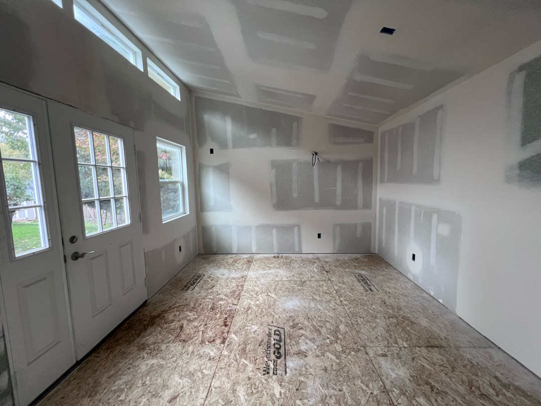 Mudroom before — raw drywall, unpainted seams